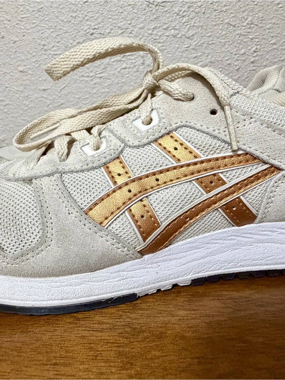 ASICS Women’s Cream Sneakers with Metallic Gold Stripes